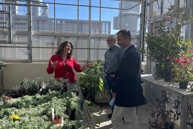 Provost Antony taking a tour of the greenhouse.