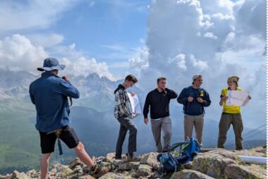 People getting picture taken of on rocks