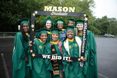Group of students at 2024 graduation, standing in regalia. 