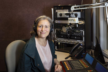 Faculty member Alessandra Luchini pictured in the WGMU radio booth for the Access to Excellence Podcast