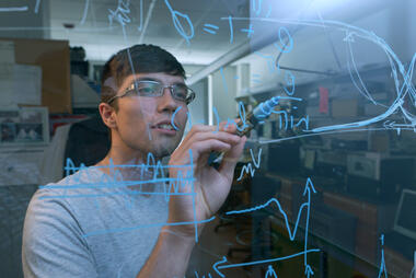 Physics student working through an equation