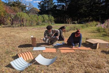 Three students starting to build their raised garden bed