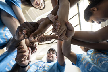 Students linking arms as part of the Global STEM Scholars Program